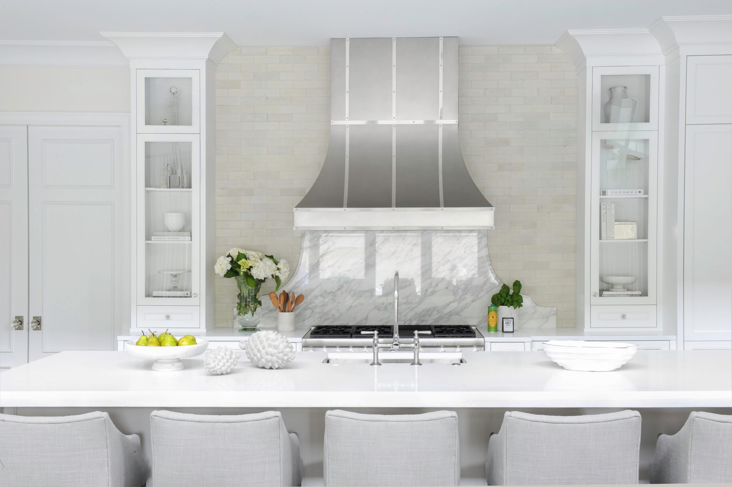 Bright white kitchen with custom range hood for dealer consultation CTA