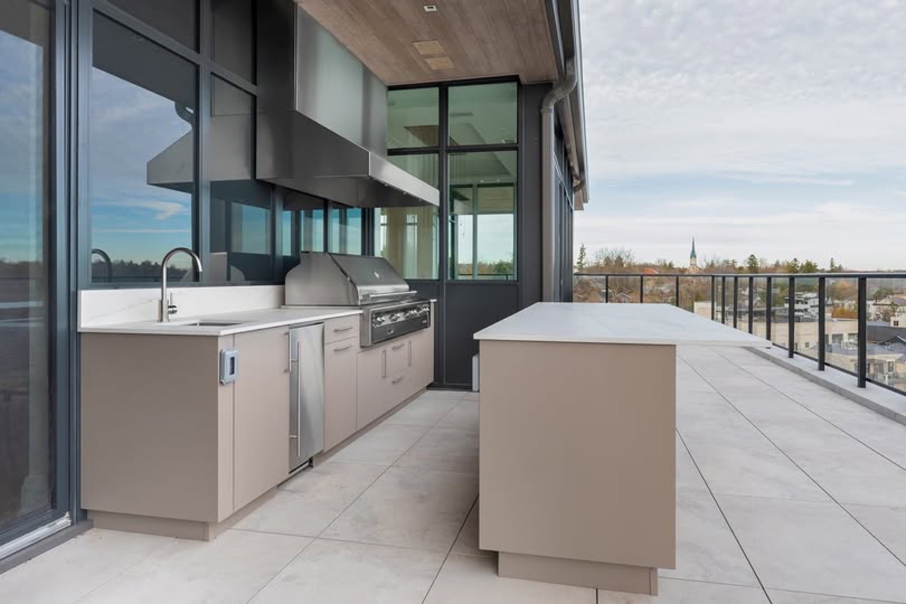 Outdoor kitchen with Vent-A-Hood ventilation over a grill.