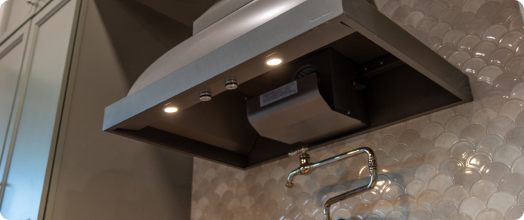 Range hood underside showing the blower assembly sticker location
